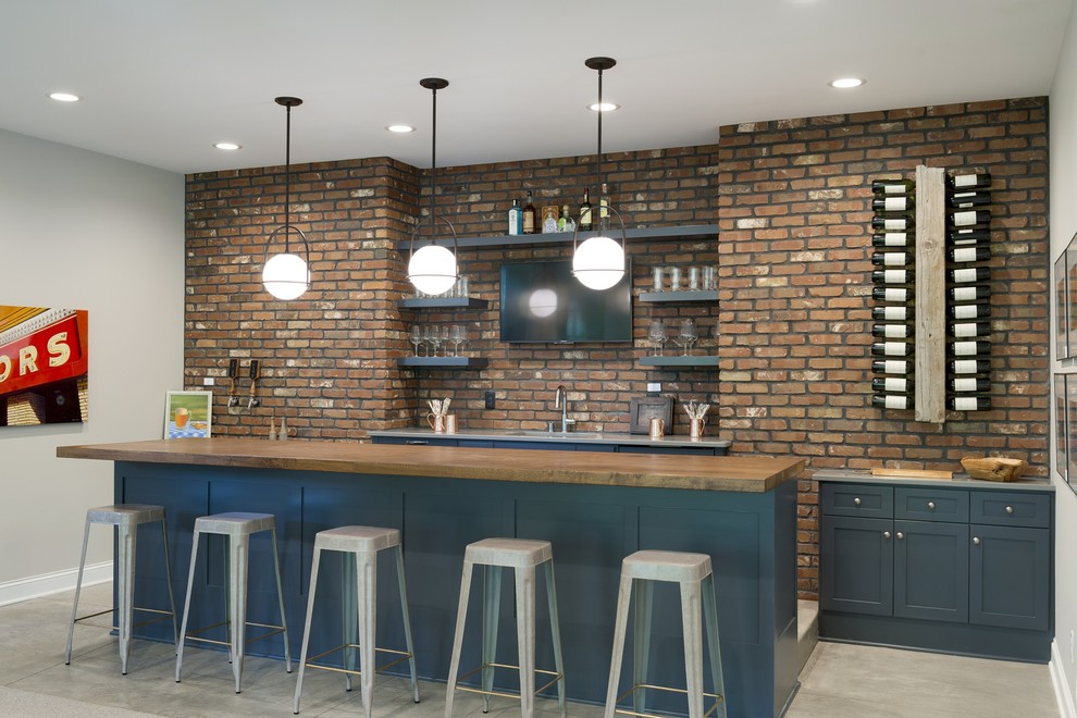 Large beach style single-wall seated home bar in Minneapolis with an undermount sink, blue cabinets, brick splashback, grey floor, shaker cabinets, quartz benchtops, brown splashback, carpet and grey benchtop.