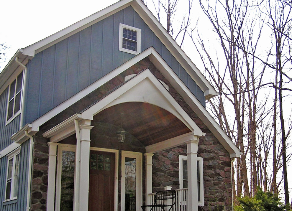 Photo of a mid-sized arts and crafts two-storey blue house exterior in DC Metro with mixed siding, a gable roof and a shingle roof.
