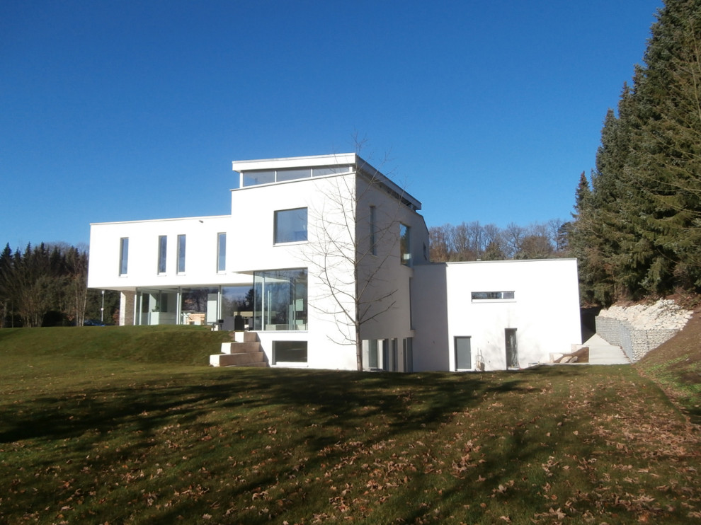 Geräumiges Modernes Haus mit Putzfassade, weißer Fassadenfarbe und Flachdach