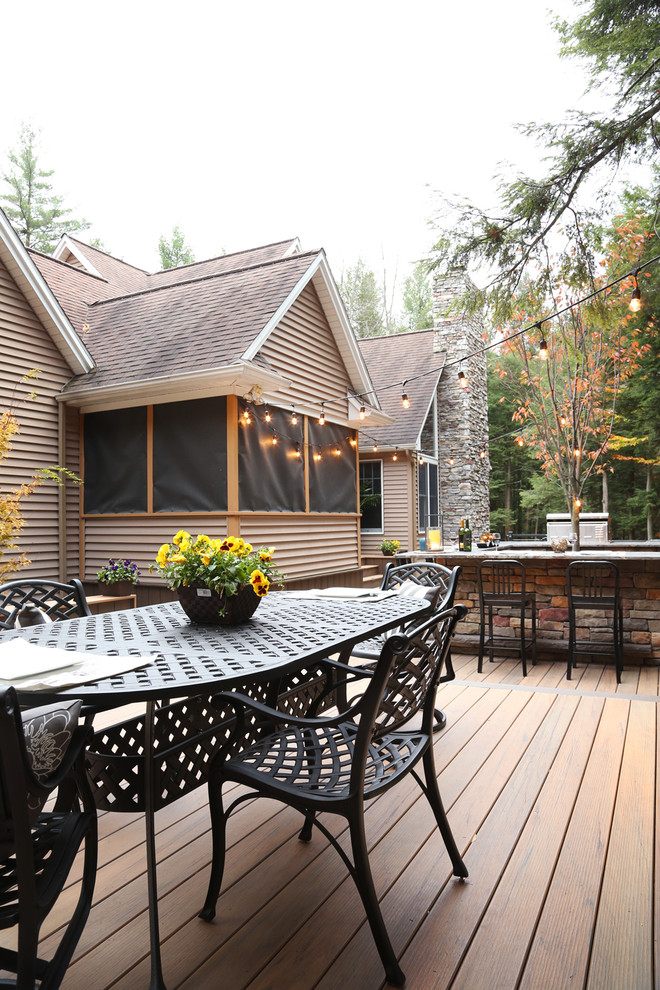 Example of a mid-sized eclectic backyard outdoor kitchen deck design with no cover