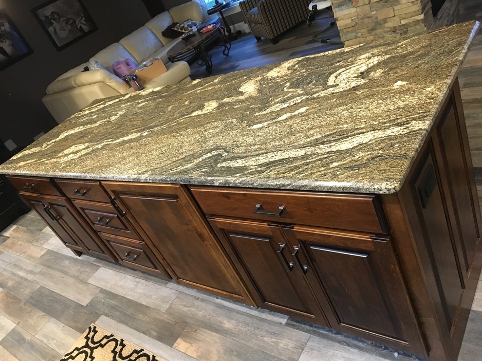 Home design - transitional ceramic tile home design idea with raised-panel cabinets, medium tone wood cabinets, granite countertops and an island
