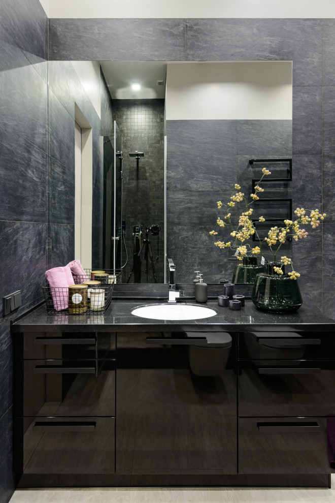 Photo of a large contemporary master bathroom in Novosibirsk with flat-panel cabinets, black cabinets, black tile, ceramic tile, black walls, ceramic floors, an undermount sink, solid surface benchtops, grey floor and black benchtops.