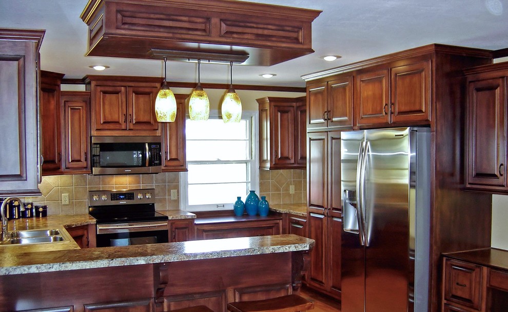 Inspiration for a timeless u-shaped eat-in kitchen remodel in Austin with raised-panel cabinets, stainless steel appliances, engineered wood floors and a peninsula