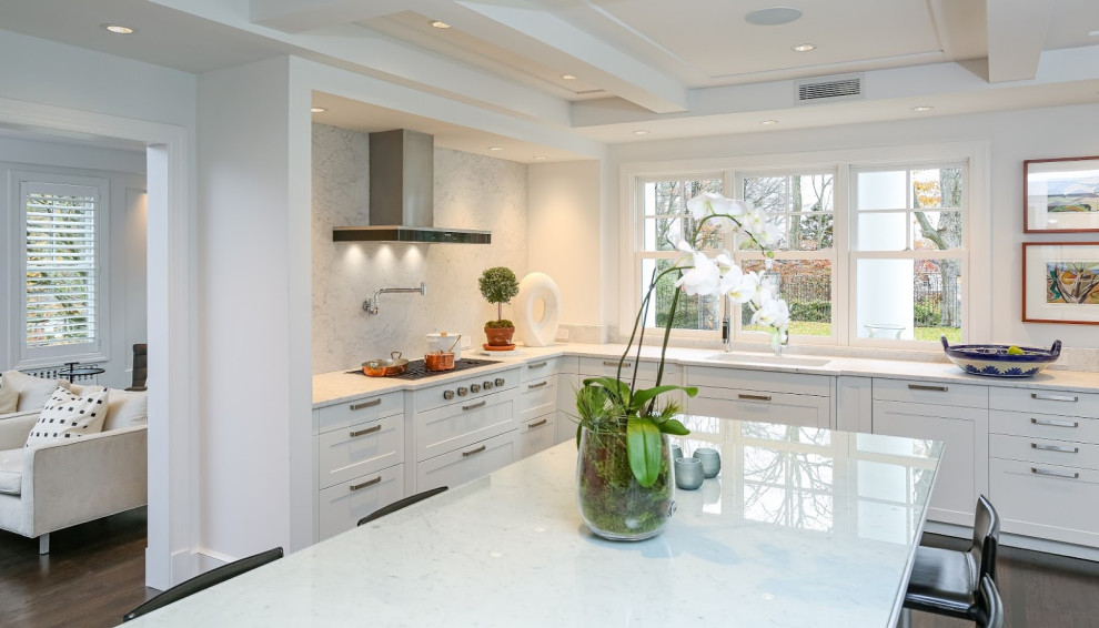 Design ideas for an expansive modern eat-in kitchen in New York with shaker cabinets, white cabinets and with island.