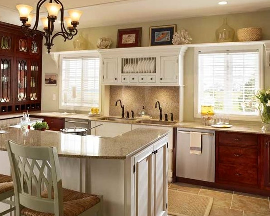 Example of a mid-sized classic ceramic tile enclosed kitchen design with a drop-in sink, recessed-panel cabinets, white cabinets, granite countertops, beige backsplash, stainless steel appliances and a peninsula