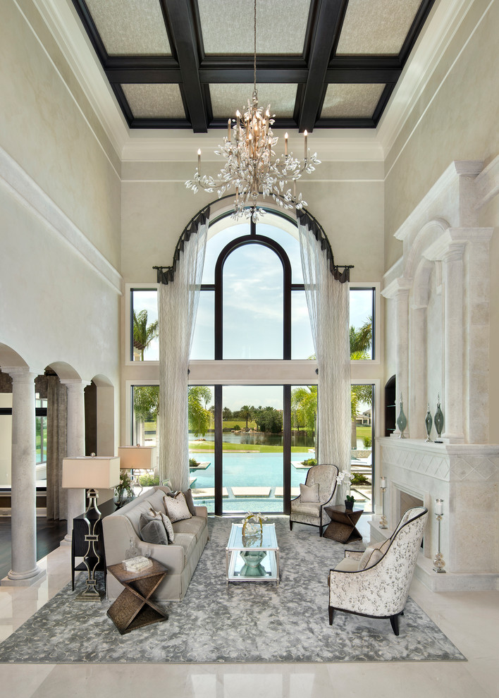 Inspiration for an expansive mediterranean formal open concept living room in Miami with beige walls, marble floors, a standard fireplace, a stone fireplace surround, no tv and beige floor.