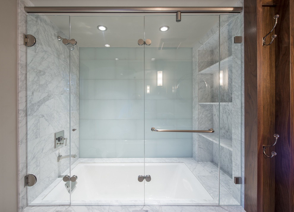 Design ideas for a transitional bathroom in San Francisco with an undermount sink, shaker cabinets, medium wood cabinets, marble benchtops, an alcove tub, a shower/bathtub combo, a one-piece toilet, green tile, glass tile, grey walls and marble floors.