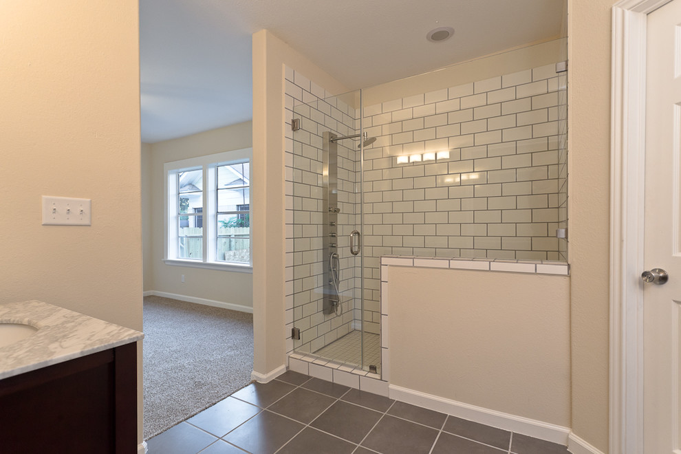 This is an example of a mid-sized transitional bathroom in Houston with a console sink and a double shower.
