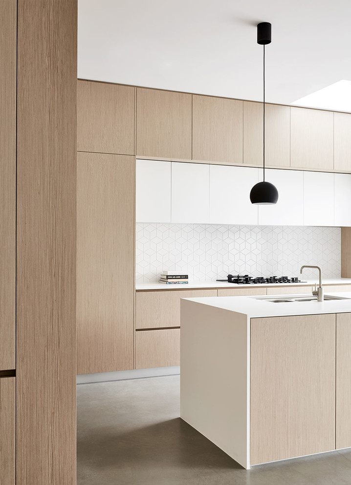 Modern eat-in kitchen in Melbourne with black appliances, with island and ceramic splashback.