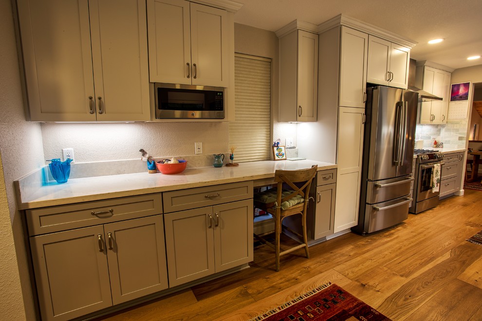 Large transitional galley light wood floor and brown floor open concept kitchen photo in Sacramento with a farmhouse sink, shaker cabinets, gray cabinets, quartz countertops, gray backsplash, stone tile backsplash, stainless steel appliances, no island and white countertops