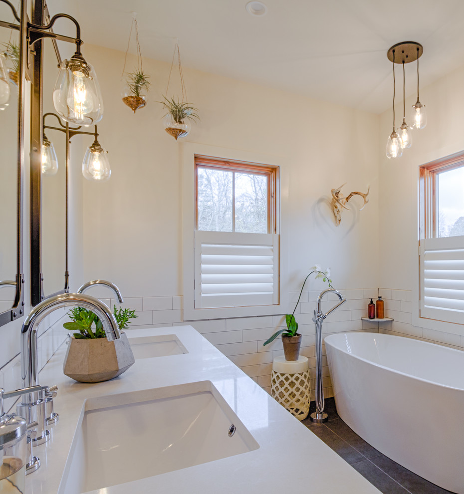 This is an example of a country bathroom in Other with flat-panel cabinets, a freestanding tub, white tile, subway tile, yellow walls, an undermount sink, engineered quartz benchtops and grey floor.