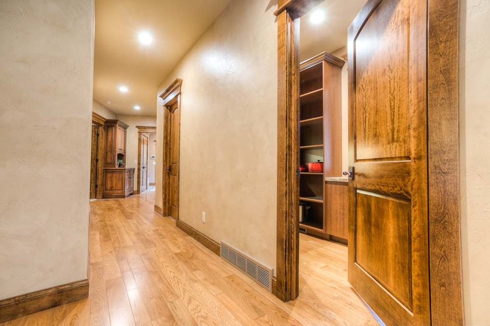 Large transitional hallway in Other with beige walls.
