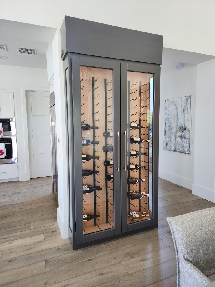 Photo of a medium sized contemporary wine cellar in Austin with display racks.