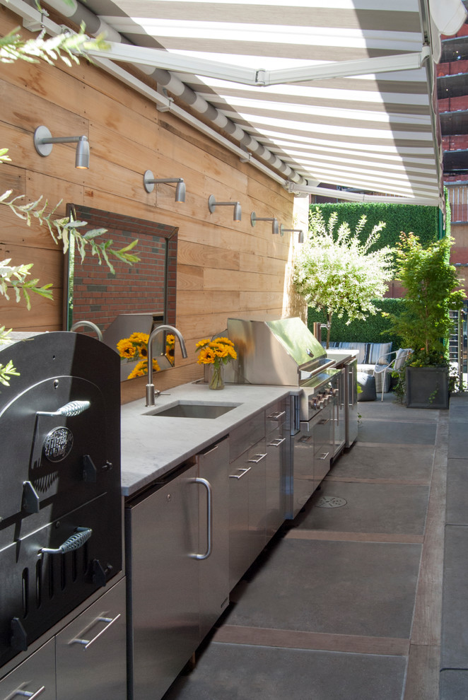 Inspiration for a large contemporary rooftop rooftop deck remodel in New York with an awning and a bbq area