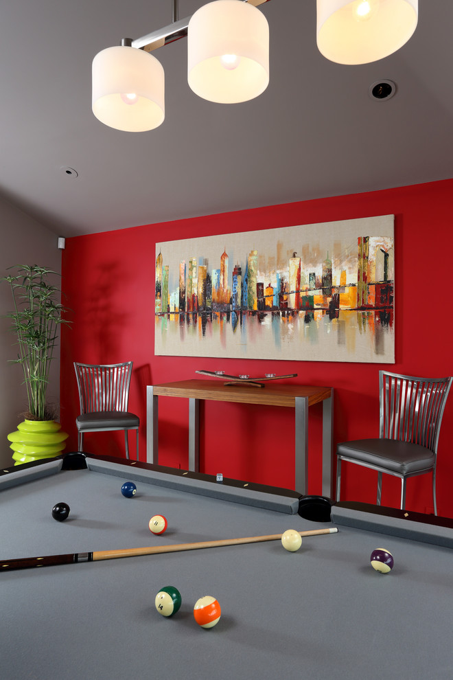 Design ideas for a mid-sized contemporary enclosed family room in San Francisco with a game room, red walls, marble floors, a standard fireplace, a stone fireplace surround and no tv.