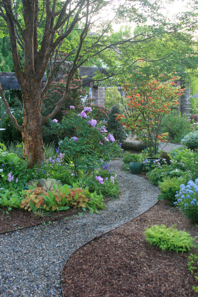 This is an example of a traditional shaded garden in New York with a garden path and gravel.
