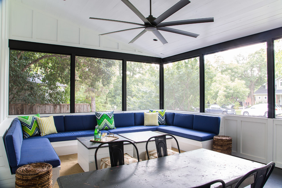 This is an example of a transitional screened-in verandah in Austin with a roof extension.