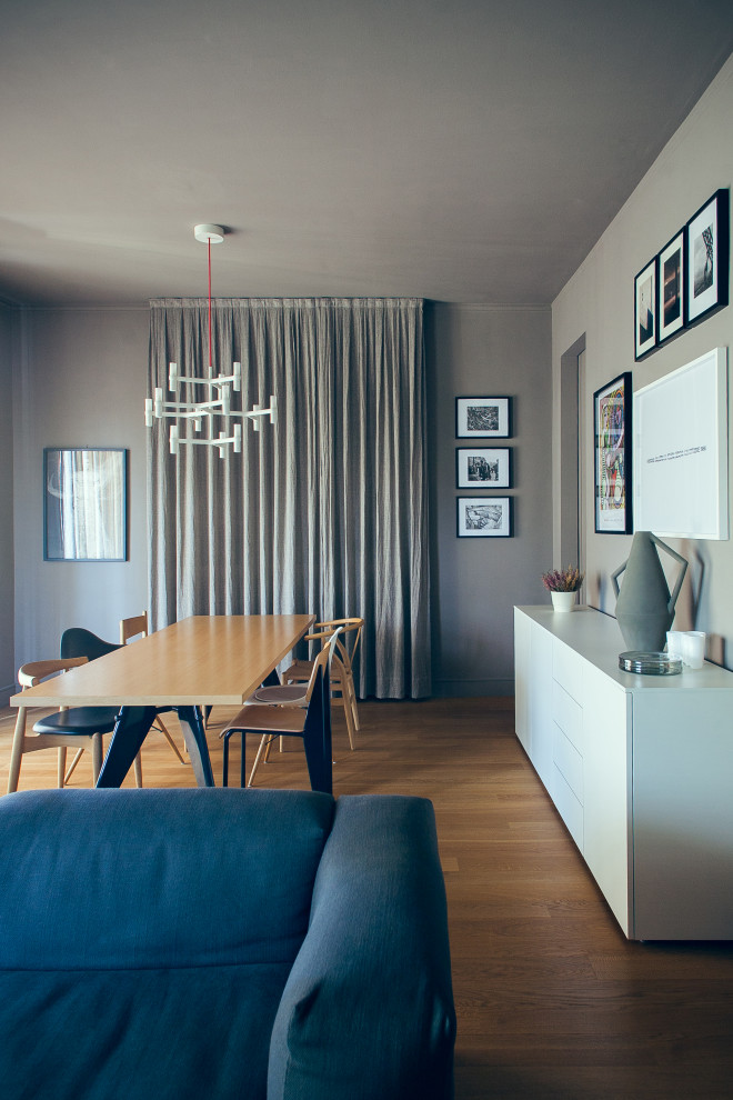 Inspiration for a mid-sized midcentury open plan dining with grey walls and light hardwood floors.