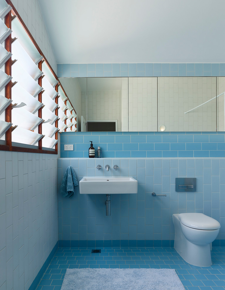 Inspiration for a small contemporary kids bathroom in Brisbane with glass-front cabinets, blue tile, ceramic tile, tile benchtops and blue benchtops.