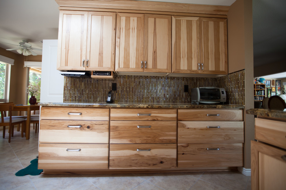 Inspiration for a large transitional galley ceramic tile enclosed kitchen remodel in Phoenix with an undermount sink, recessed-panel cabinets, light wood cabinets, granite countertops, brown backsplash, glass tile backsplash and stainless steel appliances