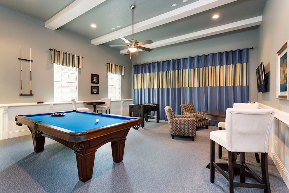 This is an example of a transitional open concept family room in Orlando with a game room, beige walls, carpet and a wall-mounted tv.