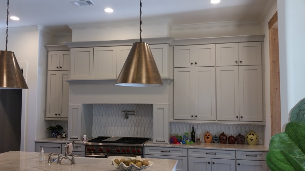 Example of a mid-sized transitional eat-in kitchen design in Birmingham with shaker cabinets, gray cabinets, gray backsplash, stainless steel appliances and an island