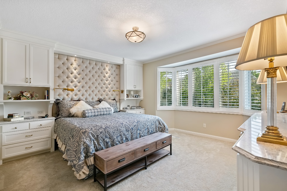 This is an example of a mid-sized traditional master bedroom in Minneapolis with beige walls, carpet and beige floor.