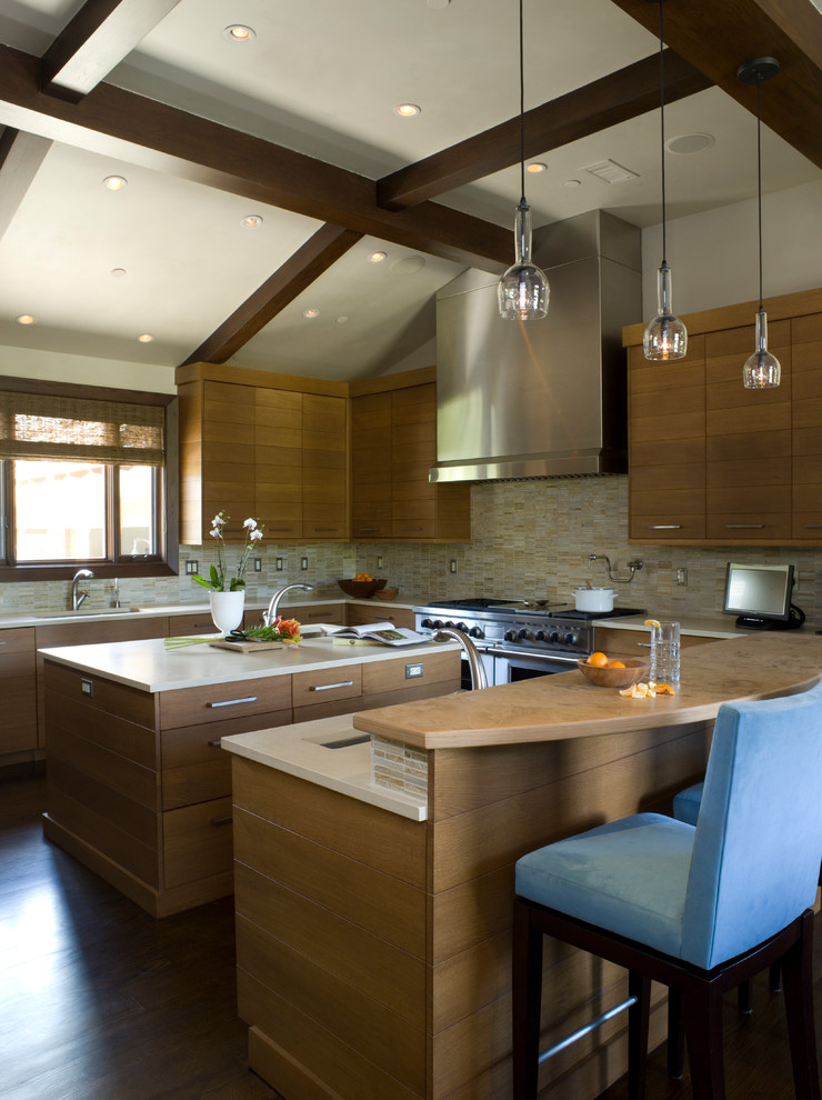Large contemporary u-shaped kitchen in Denver with an undermount sink, flat-panel cabinets, medium wood cabinets, beige splashback, matchstick tile splashback and dark hardwood floors.