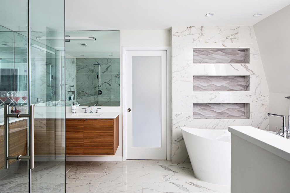Inspiration for a large contemporary bathroom in DC Metro with brown cabinets, a corner shower, gray tile, a hinged shower door and white benchtops.