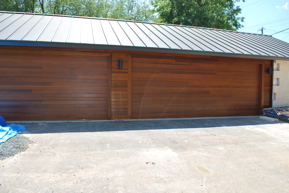 This is an example of a large contemporary detached four-car garage in Austin.
