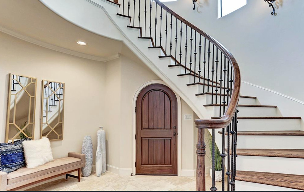 Large transitional wooden curved mixed material railing staircase photo in Houston with painted risers