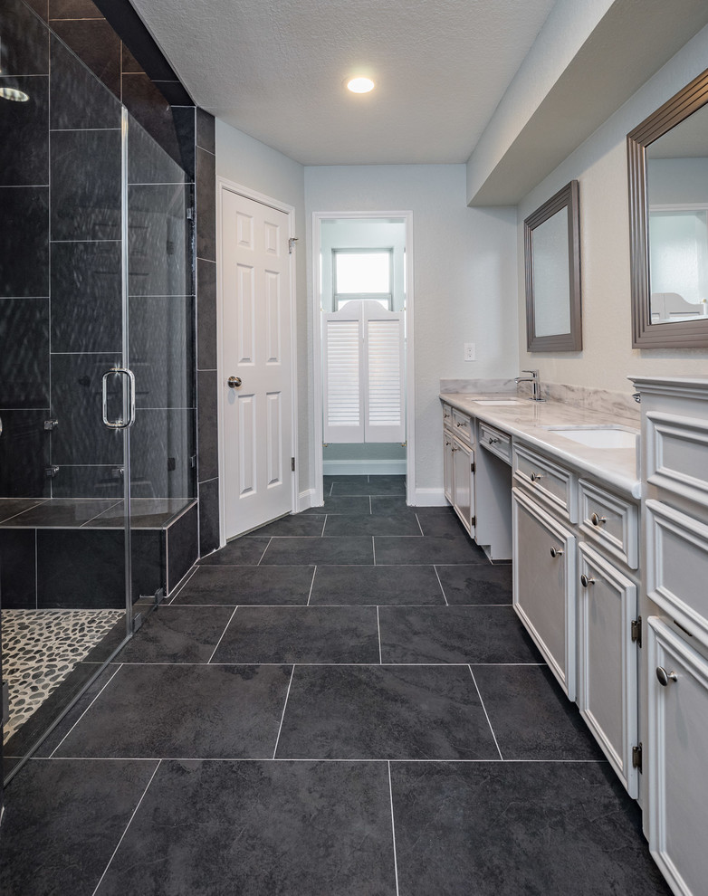 Large modern master bathroom in Houston with raised-panel cabinets, grey cabinets, an alcove shower, a two-piece toilet, black tile, porcelain tile, grey walls, porcelain floors, an undermount sink and granite benchtops.