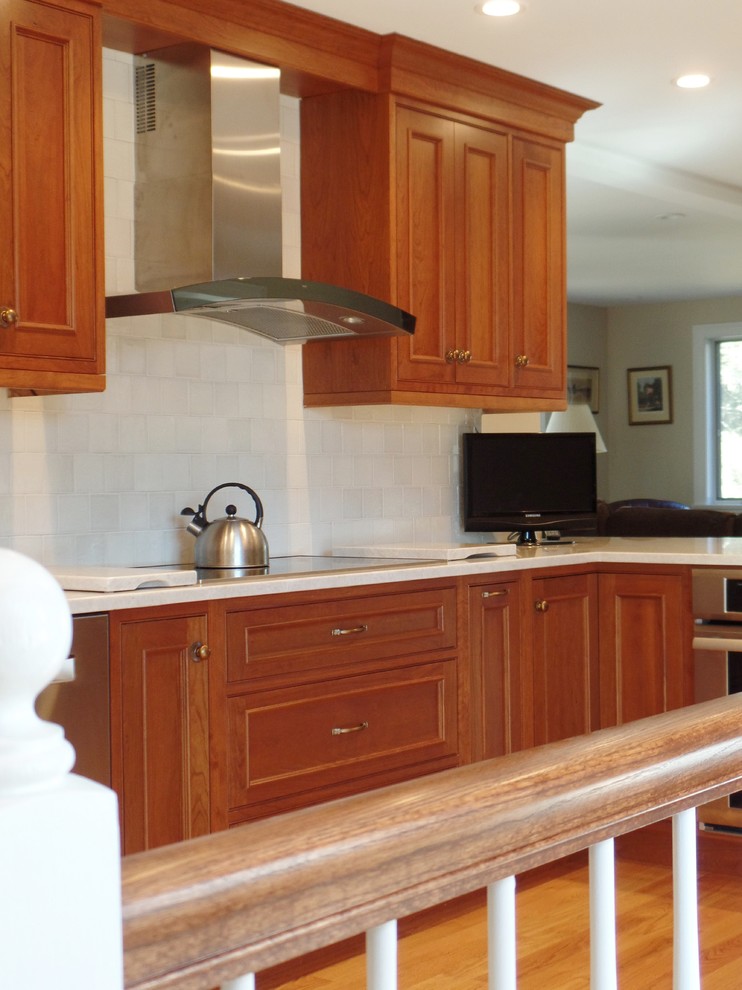 Inspiration for a large transitional l-shaped light wood floor open concept kitchen remodel with a single-bowl sink, beaded inset cabinets, medium tone wood cabinets, quartzite countertops, white backsplash, ceramic backsplash, stainless steel appliances and no island
