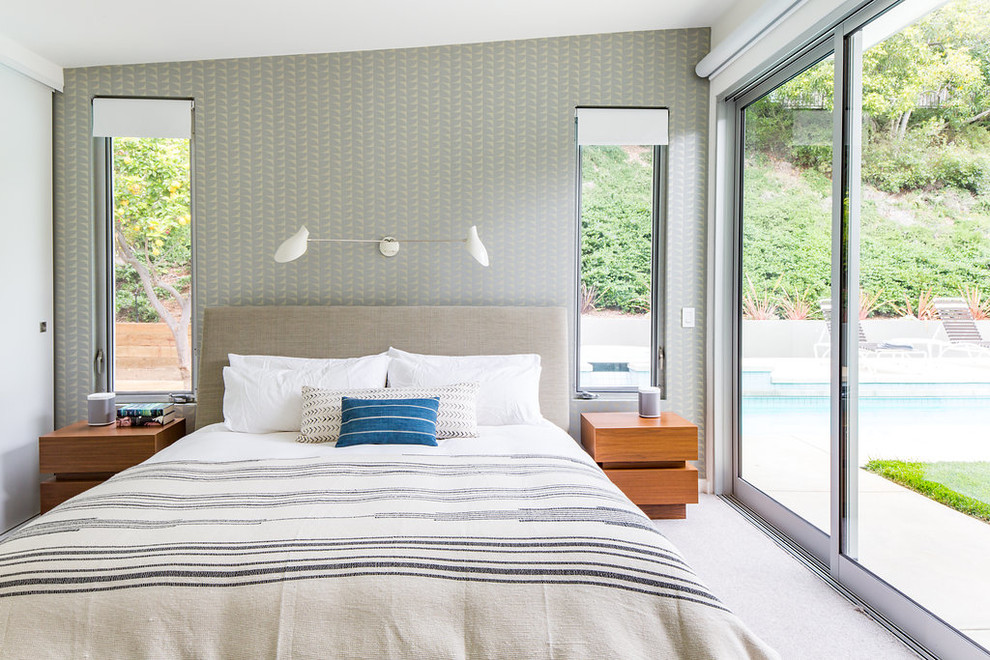 This is an example of a midcentury master bedroom in Los Angeles with carpet, grey walls and beige floor.