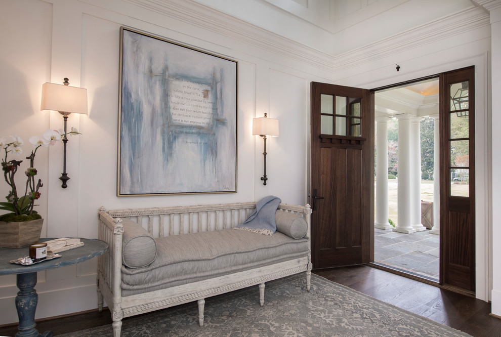 Design ideas for a traditional foyer in Atlanta with white walls, dark hardwood floors, a double front door, a dark wood front door and brown floor.