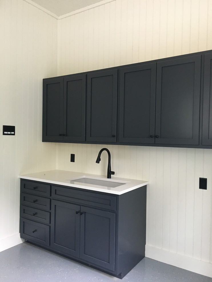 Design ideas for a small country single-wall utility room in Philadelphia with a drop-in sink, grey cabinets, white walls, a side-by-side washer and dryer and shaker cabinets.