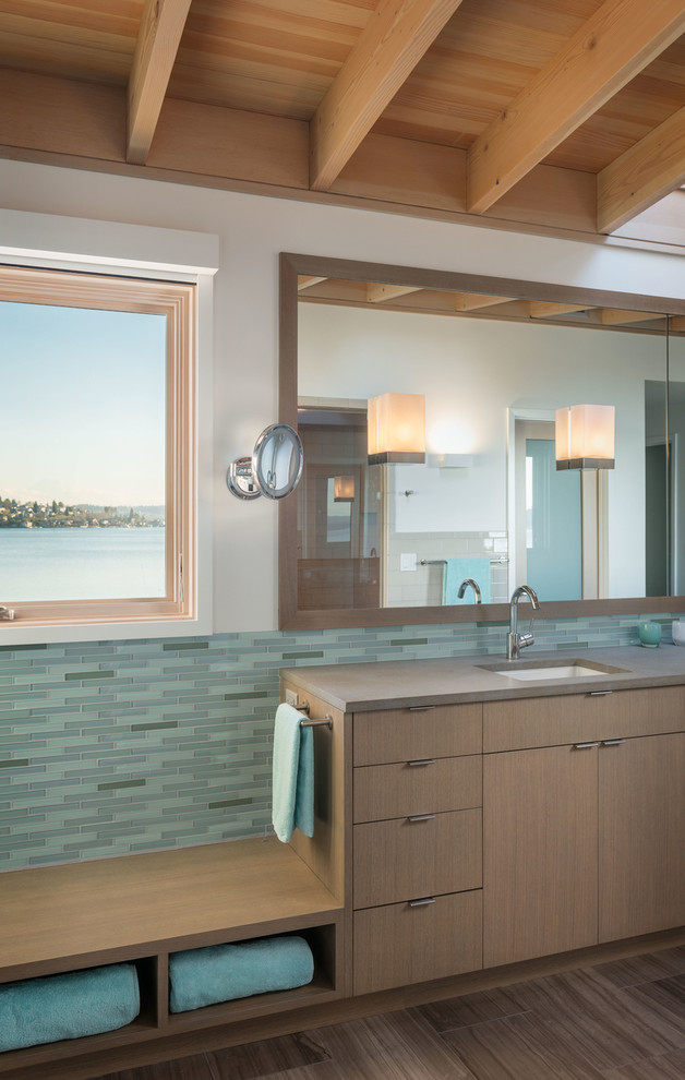 This is an example of a contemporary master bathroom in Seattle with an undermount sink, flat-panel cabinets, medium wood cabinets, an alcove shower, green tile, glass tile, white walls and porcelain floors.