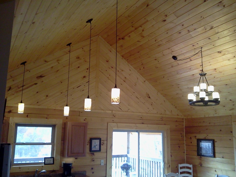 Mountain style l-shaped dark wood floor eat-in kitchen photo with a drop-in sink, light wood cabinets, laminate countertops, stainless steel appliances and an island