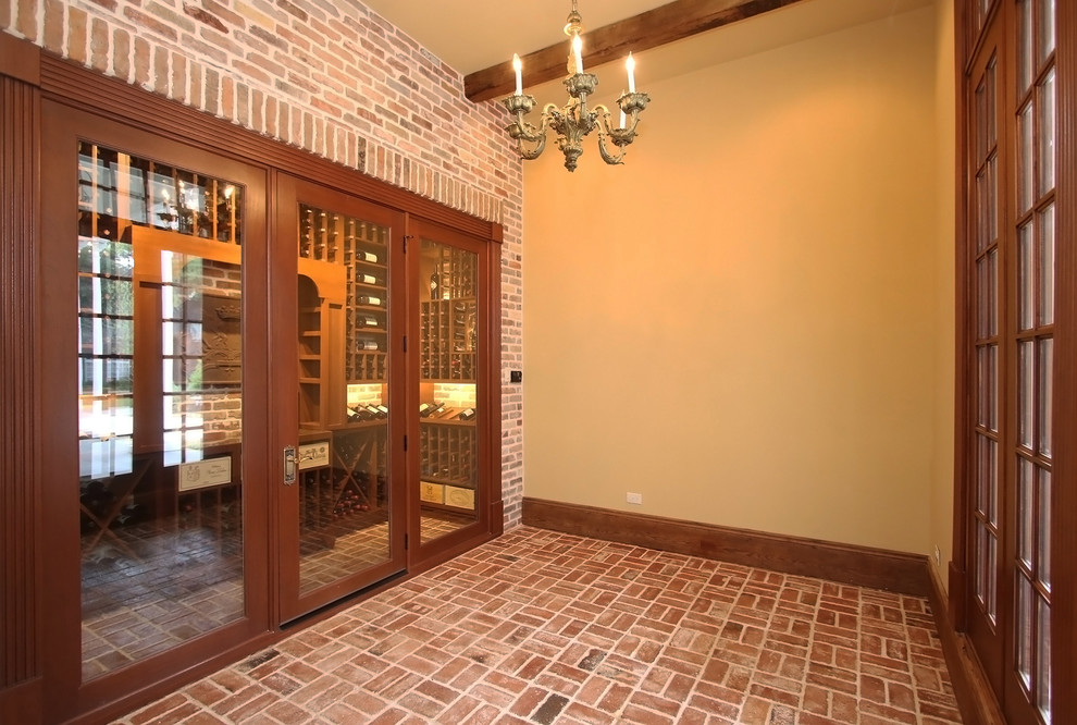 Mid-sized traditional wine cellar in Houston with brick floors, display racks and red floor.
