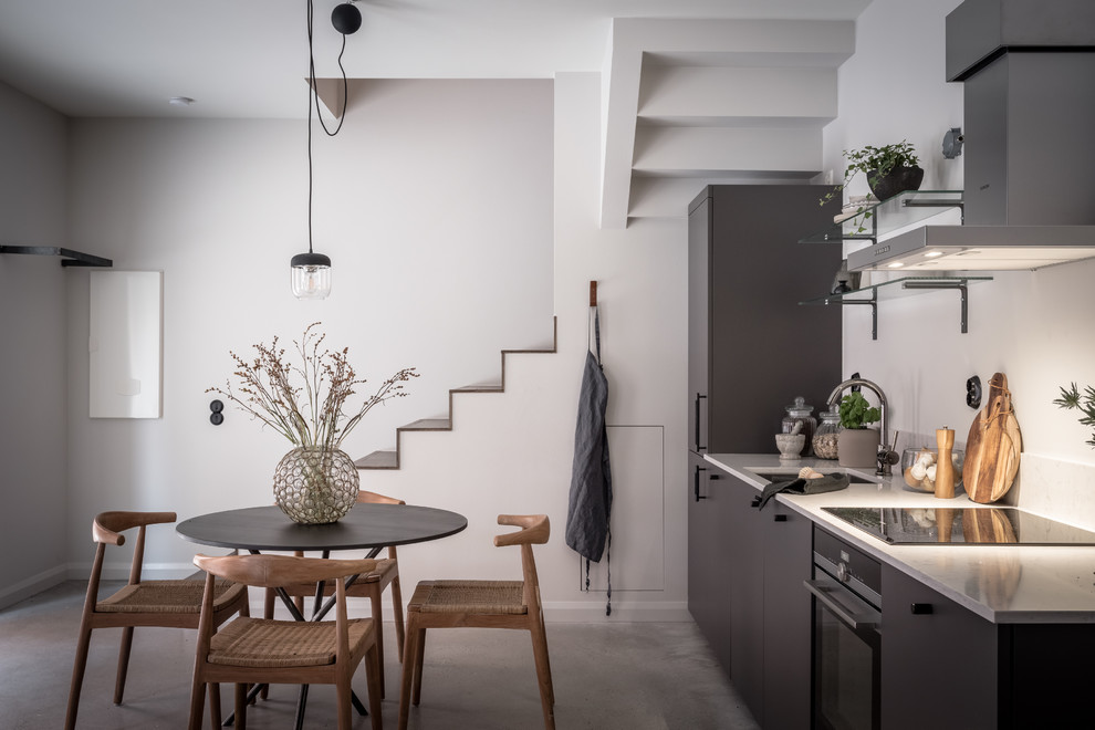 This is an example of a mid-sized contemporary kitchen in Gothenburg with white splashback, marble splashback, panelled appliances and no island.