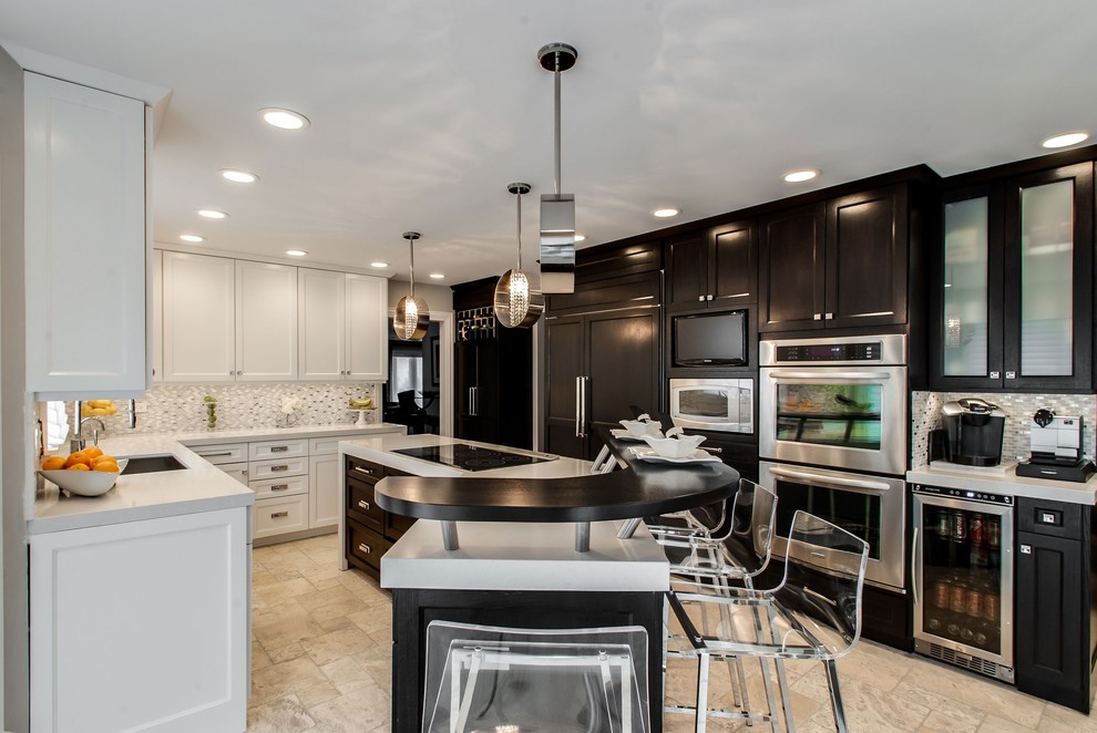 Photo of a contemporary u-shaped separate kitchen in Chicago with an undermount sink, recessed-panel cabinets, black cabinets, grey splashback and black appliances.