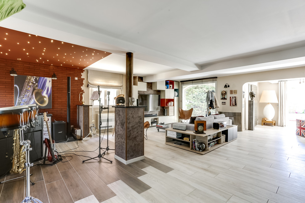 This is an example of a large contemporary open concept living room in Other with a music area, orange walls, ceramic floors, a wall-mounted tv and beige floor.