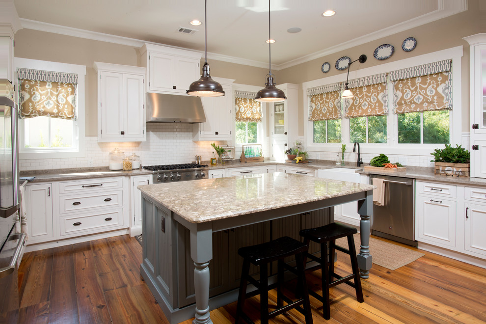 This is an example of a mid-sized country u-shaped eat-in kitchen in Charleston with a farmhouse sink, raised-panel cabinets, white cabinets, subway tile splashback, stainless steel appliances, medium hardwood floors and with island.