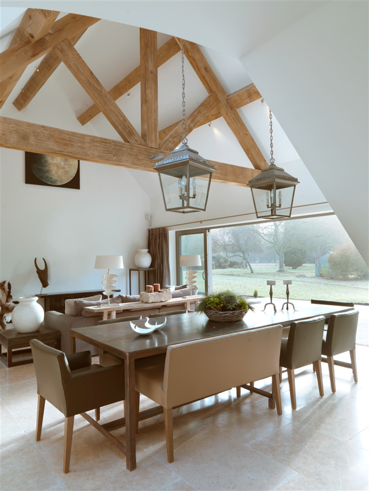 Inspiration for a large country open plan dining in Oxfordshire with white walls and limestone floors.
