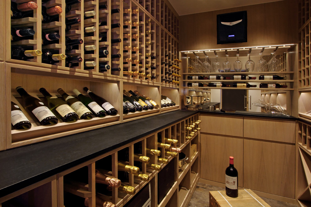 Photo of a contemporary wine cellar in London with storage racks.