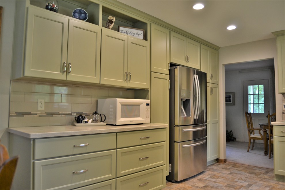 Inspiration for a mid-sized transitional l-shaped ceramic tile and beige floor eat-in kitchen remodel with an undermount sink, shaker cabinets, green cabinets, white backsplash, subway tile backsplash, stainless steel appliances and no island