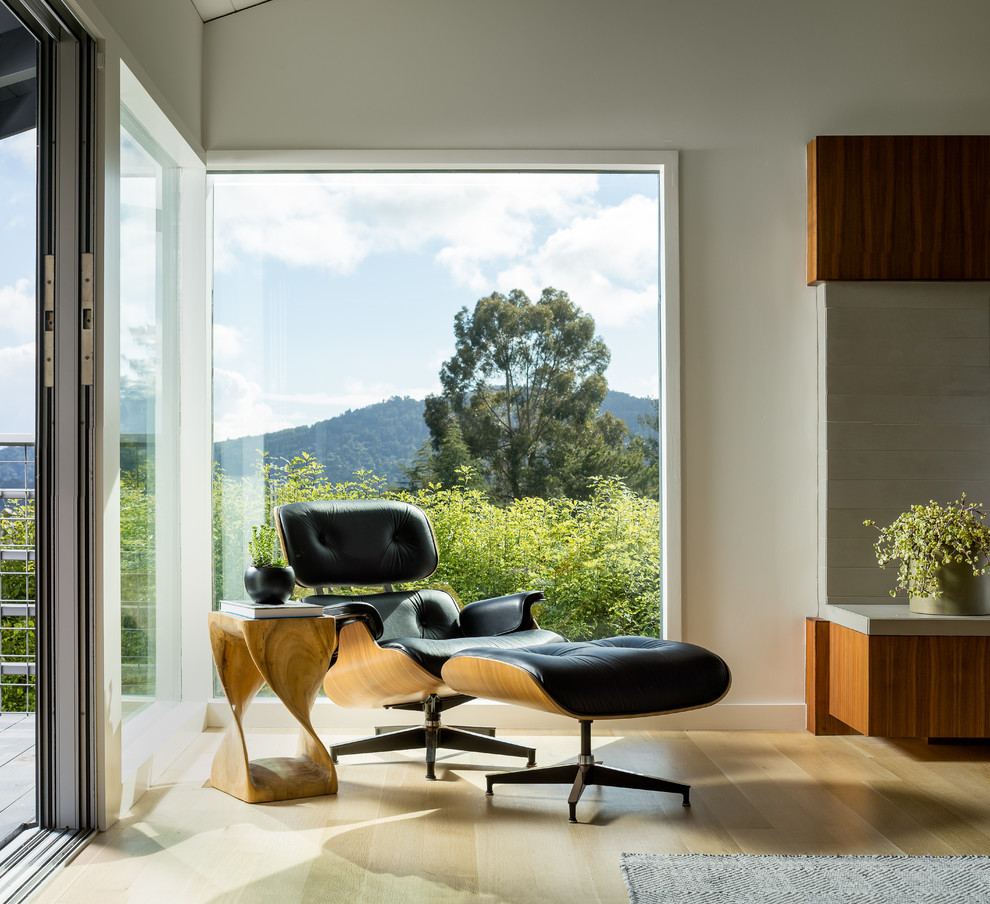 Example of a large 1950s open concept light wood floor and vaulted ceiling living room design in San Francisco with white walls, a standard fireplace and a tile fireplace
