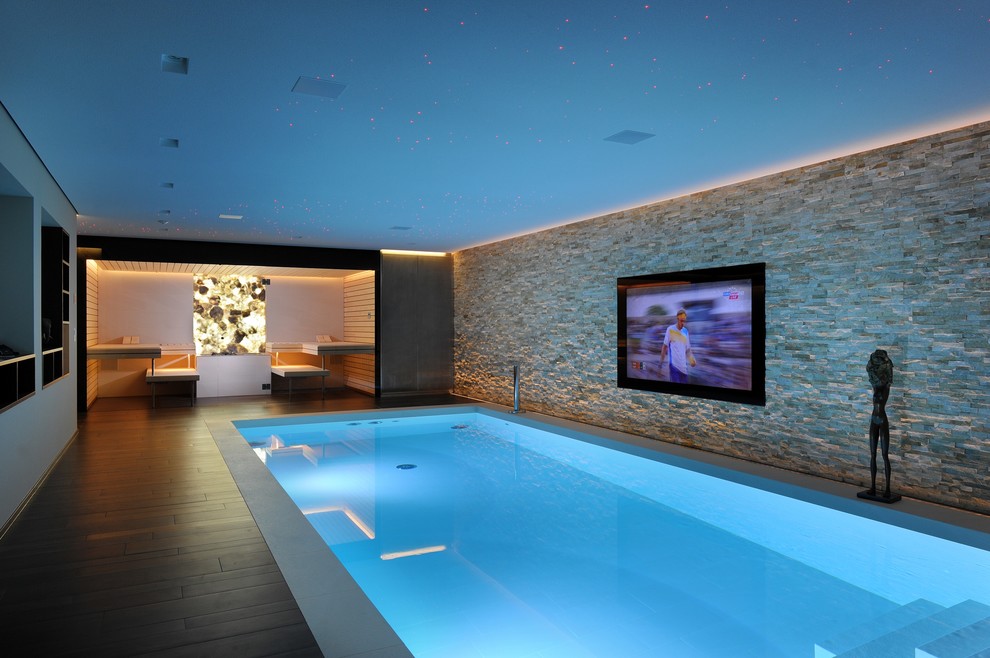 This is an example of a contemporary indoor rectangular pool in London.