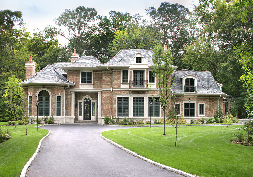 Photo of an expansive traditional two-storey brick brown exterior in New York with a hip roof.