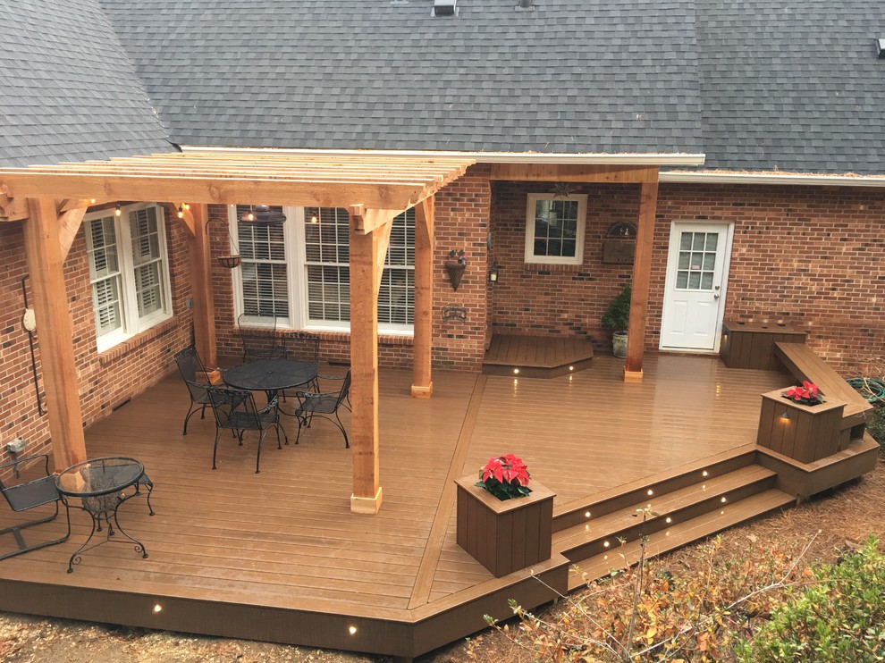 Inspiration for a large timeless backyard deck remodel with a pergola